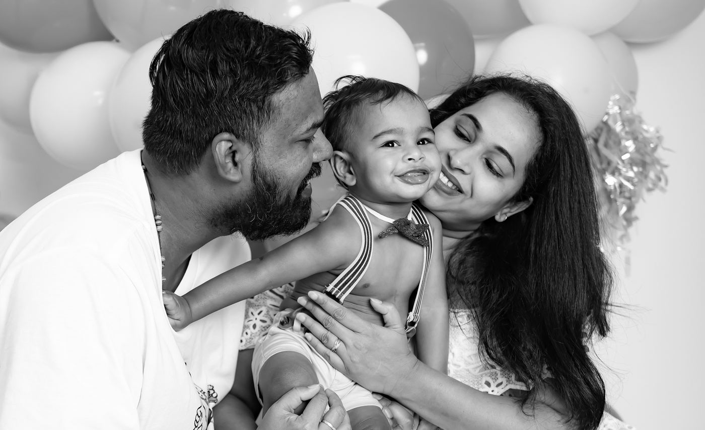 Black and white family portrait with parents and child