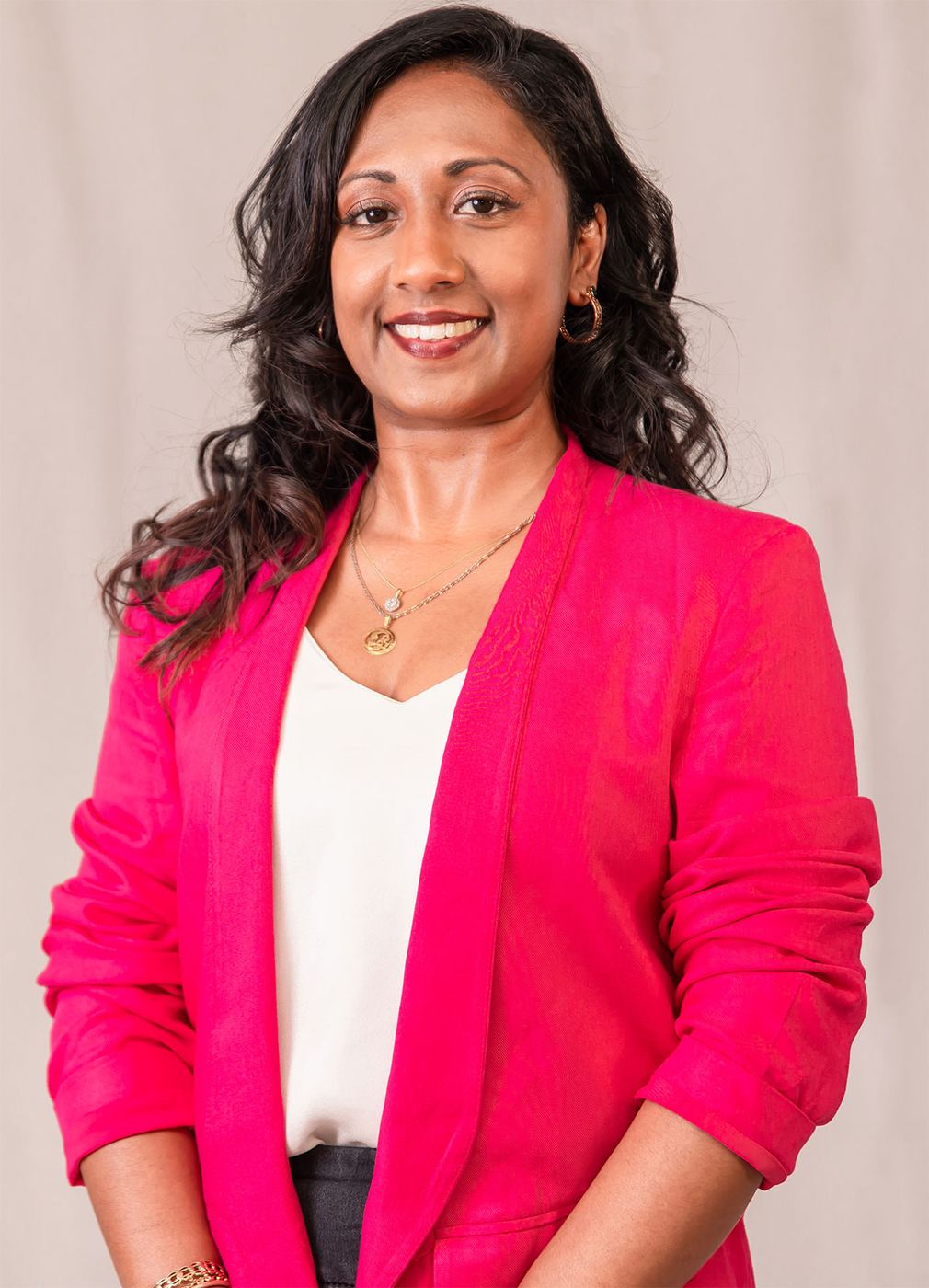Professional headshot with bright pink blazer